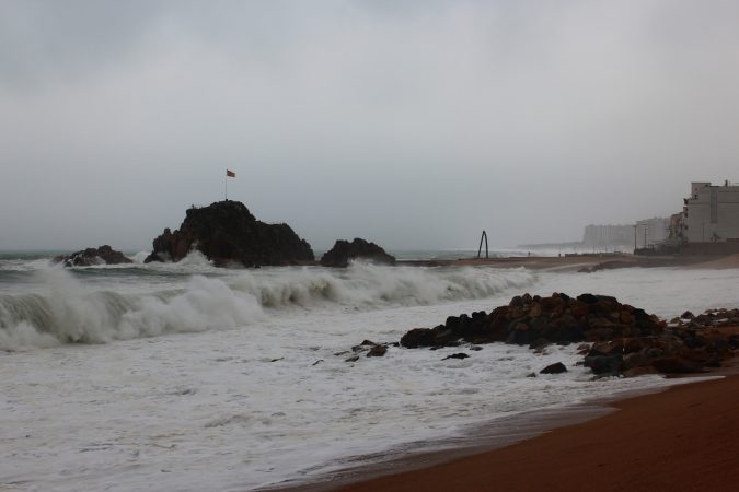 Olas de un temporal de levante rompiendo en la playa de Blanes, en la Costa Brava, bajo un cielo gris
