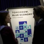 Asistentes junto al cartel del Tomorrow.Blue Economy World Congress en una edición anterior en Fira de Barcelona (foto de archivo)